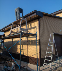 Installation of metal drain on the roof of the house