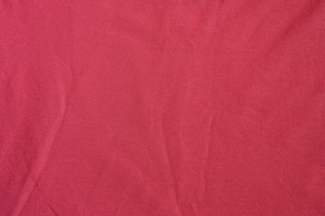 Texture of red crumpled cotton close up