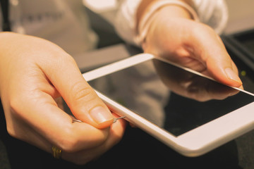 Employees are putting nano-SIM cards in the store for customers to buy women hands.