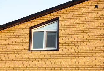 A window in a house with brick walls