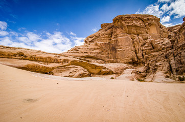 Natural arch in desert with sandstone and granite rock Wadi Rum in Jordan