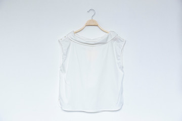 White color blouse is clothes hanger on white background.close up.