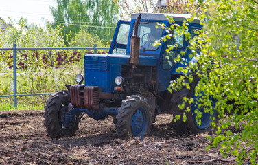 Fototapeta premium Tractor plowing soil in spring