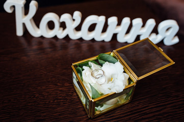 wedding rings in a glass box on the table for ceremonies
