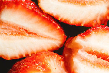 strawberry cut in half. strawberry core. half of a strawberry on a black background