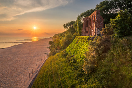 Sunrise over the ruins church in Trzesacz, Poland