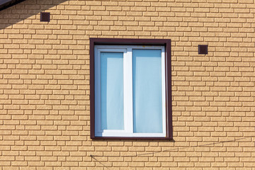 A window in a house with brick walls