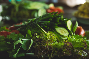 Vegetables and fruits are sliced on a wooden table. Picnic in the summer. Fresh vegetables. Party in nature.