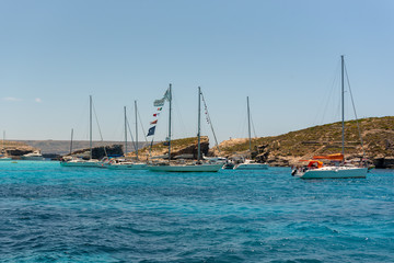 Obraz premium Panorama of the crystal clear blue waters of Santa Maria Beach in Santa Marija Bay, Comino, Malta.