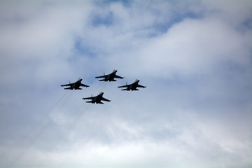 four combat aircraft in the sky