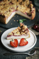 Summer dessert. Rustic berry cake with a delicate souffle and strawberry homemade lemonade on a dark background.