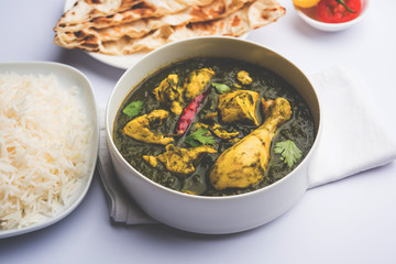 palak/spinach Chicken or Murg Saagwala served in a bowl with Naan and rice