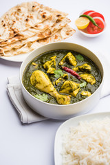 palak/spinach Chicken or Murg Saagwala served in a bowl with Naan and rice