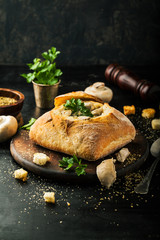 Delicious chicken cream soup with mushrooms in bread