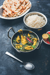 palak/spinach Chicken or Murg Saagwala served in a bowl with Naan and rice