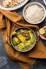 palak/spinach Chicken or Murg Saagwala served in a bowl with Naan and rice