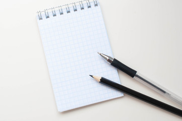 Notebook with a place for an inscription and a black pencil on a neutral background