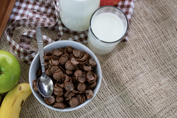 Cornflakes cereal and milk in a clay bowl. Morning breakfast.