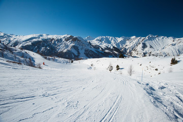 Fototapeta premium View down a piste in alpine ski resort