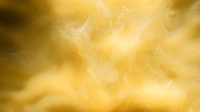 Mixed inks cloud motion. Yellow paints animation in water. Colorful smoke fusion
