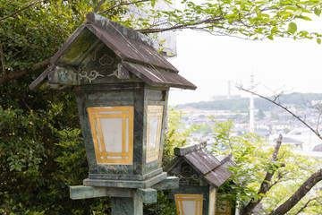 Fototapeta na wymiar The green traditional light lamp pole at shrine, Japan style.
