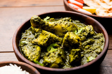 palak/spinach Chicken or Murg Saagwala served in a bowl with Naan and rice