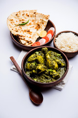 palak/spinach Chicken or Murg Saagwala served in a bowl with Naan and rice