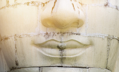 Closeup old white sculpture face with vintage warm light, Buddha immage 