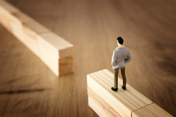 business concept image of challenge. A man standing at the edge of a gap looking forward. Problem solving and decision making.