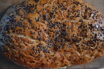 Beautiful very hearty bread homemade recipe. Brown bread with crispy crust, black caraway seeds and brown flax kernels.