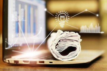 News. Computer and newspapers with virtual graphs and charts as concept for business news. Data analysis and planning                         