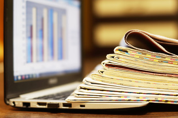 Newspapers and Laptop. Different Concepts for News - Social Network or Traditional Tabloid...