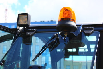 headlights and yellow flasher on excavator cab