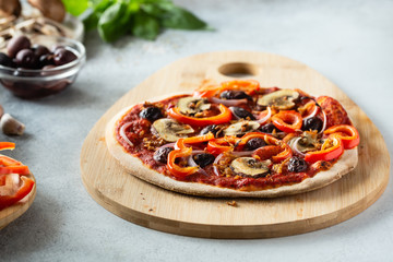 Healthy vegan pizza with vegetables and mushrooms. Vegetarian pizza and ingredients