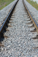 Repaired railroad tracks for freight trains with updated gray stone.