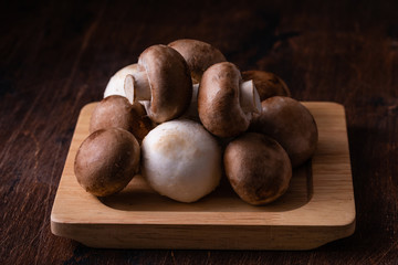 Close-up of fresh champignon mushrooms on wooden table