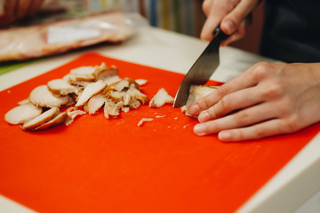 Female Hands Chopping Vegetables On A Wooden Board