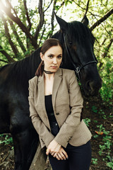 Buttom view of beautiful woman and expensive breed hourse. Outdoor shot, sport and fashion concept.