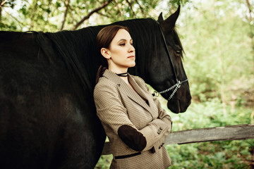 Buttom view of beautiful woman and expensive breed hourse. Outdoor shot, sport and fashion concept.