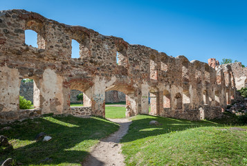 Ancient ruins of a knight's castle in Dobele. Overall view of the courtyard and surrounding area across  window openings in the wall. Dobele, Latvia.
