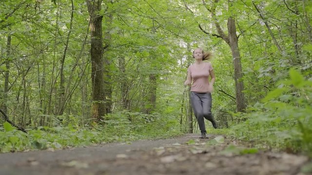 girl makes run along forest path when exhibitionist jumps out in front of her. woman feels fear and runs away from pervert man.