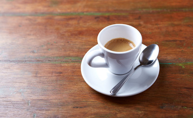 Cup of coffee on rustic wooden background. Copy space.