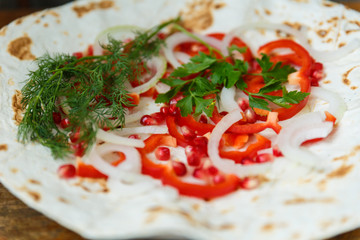 Red bell peppers, onions, pomegranate and parsley on lavash for roasted meat, sausages or sausages are served with ketchup and Armenian snack Aivar. The view from the top.