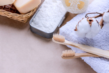 Fototapeta na wymiar Bath accessories, organic personal care products made with natural materials in reusable packages. Closeup bamboo toothbrushes on craft paper background. Say no to plastic. Zero waste concept.