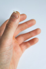 Broken nail close-up , male model hands on white background