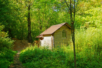 old wooden font in the forest in autumn, Russia