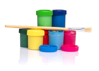 Set of Colorful Gouache jars and artist brushes isolated on white background with copy space. Cans...