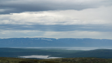 Fototapeta na wymiar Cloudy sky in high mountain tundra Khibiny