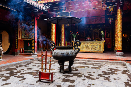 Incense sticks in large vase and large incense sticks at the foreground in Ong Bon Pagoda (Nhi Phu Mieu), Cho Lon Ho Chi Minh City, Vietnam.