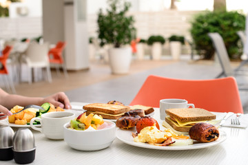 English breakfast: fried egg, bacon, beans and toast on a plate close-up. horizontal view from above
